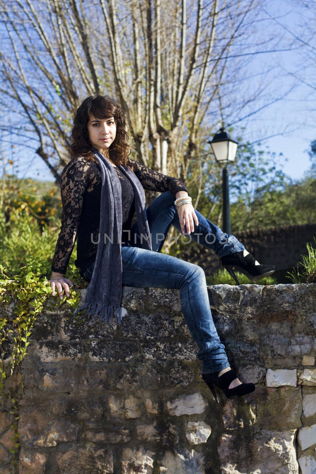 View of a beautiful girl on a urban park on a autumn set.