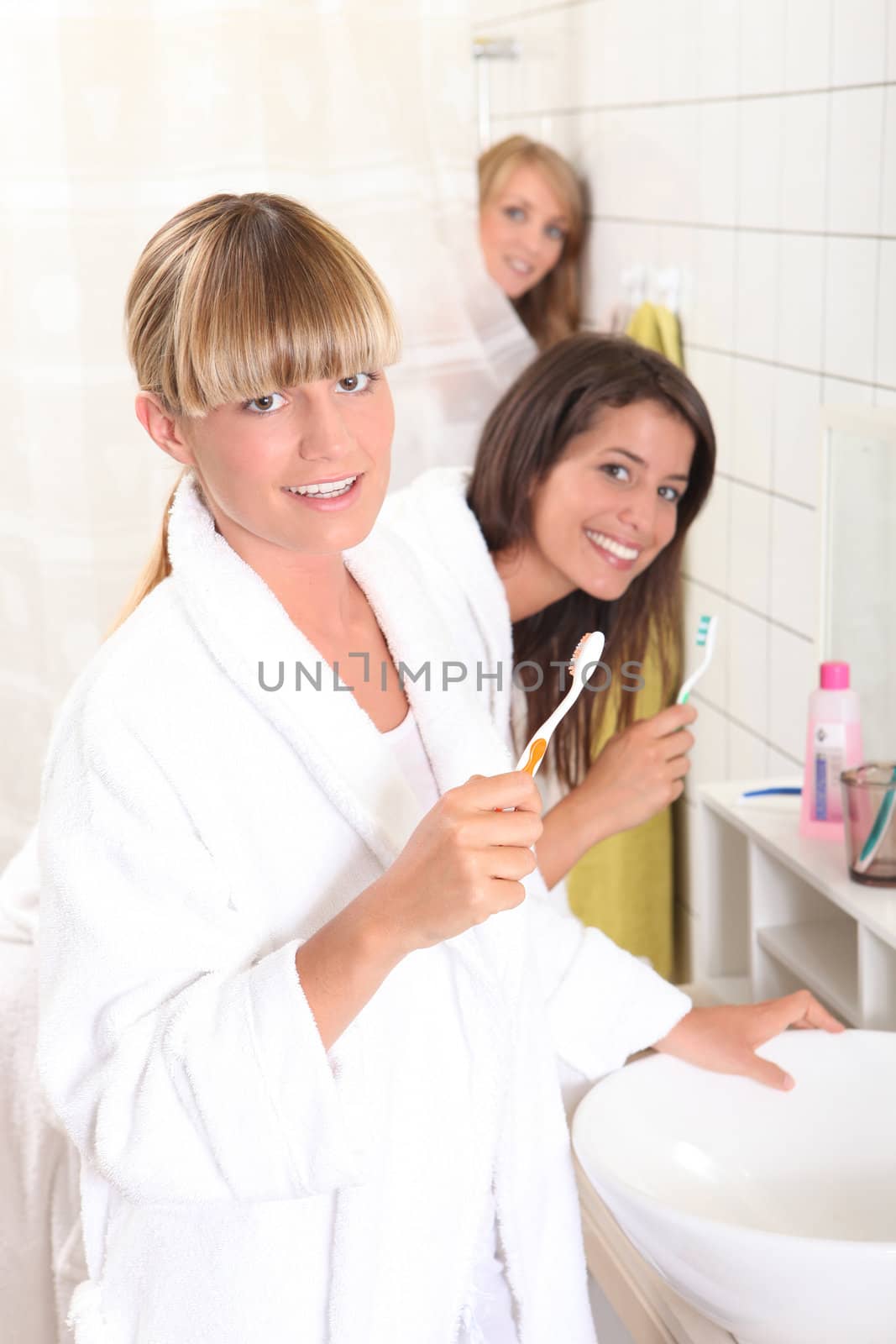 Young women in the bathroom together by phovoir