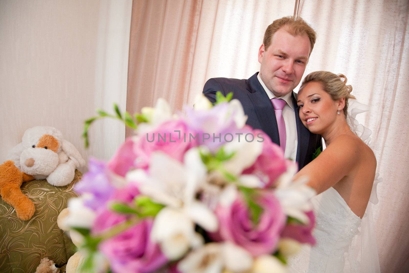 bride and groom with a flower bouquet