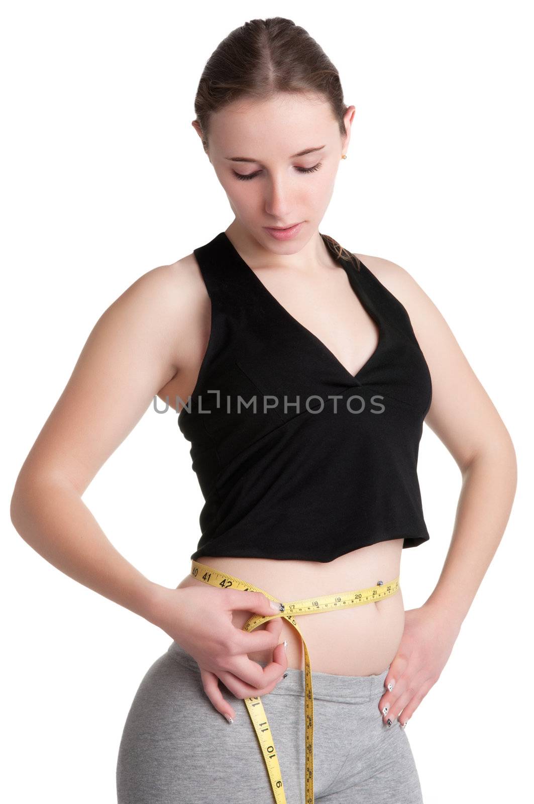 Woman measuring her waist with a yellow measuring tape, isolated in white