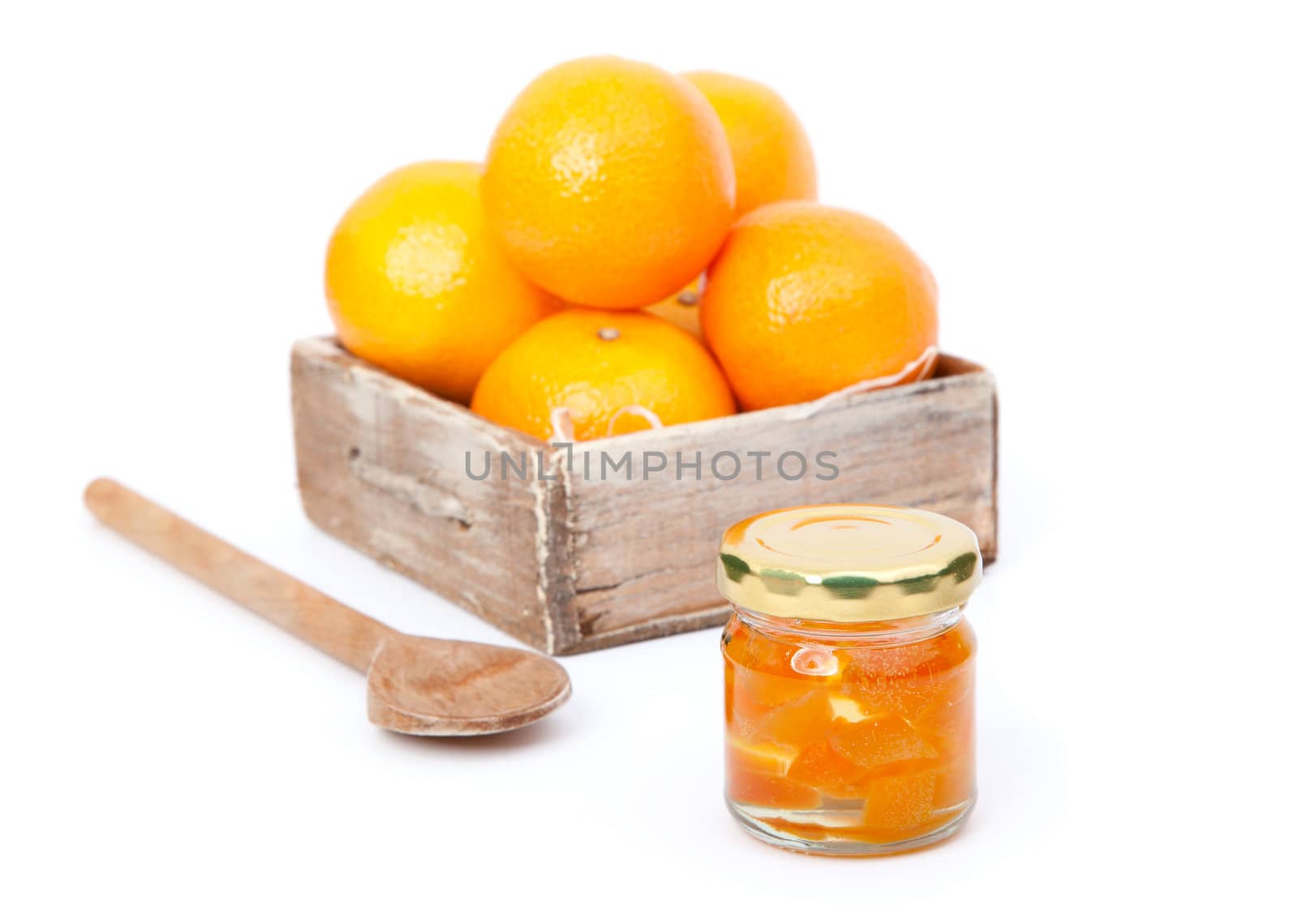 oranges in wooden box with orange jam in the  jar. on white background