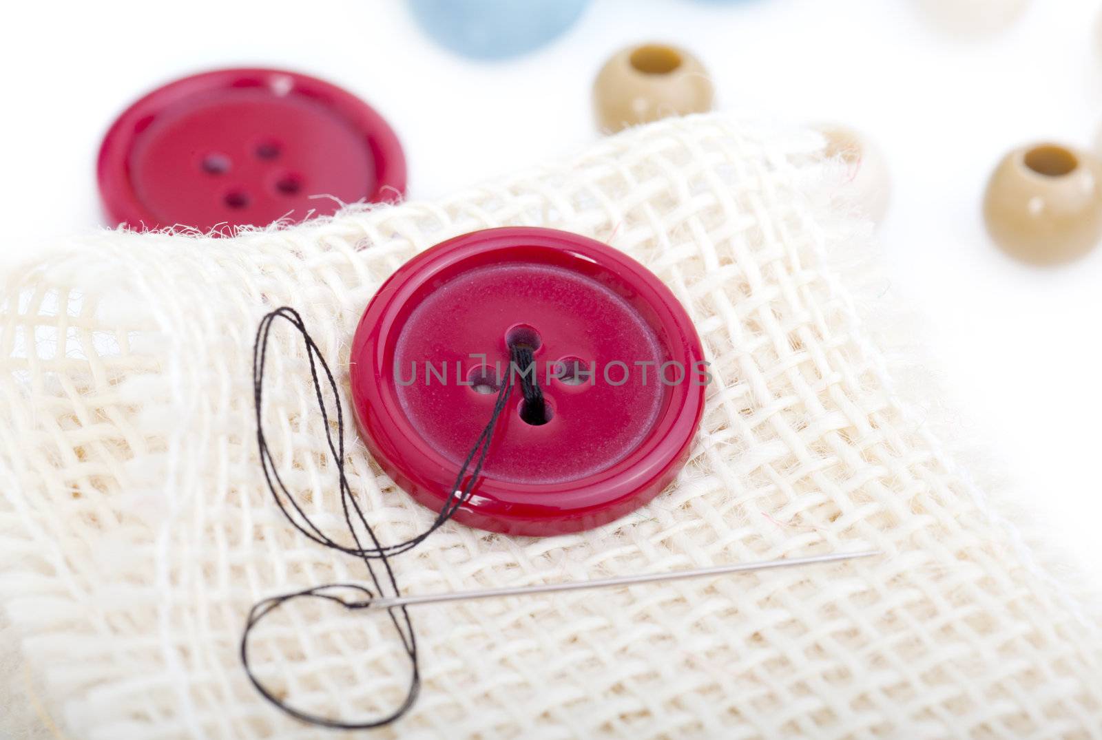 buttons, thread and needle. sewing accessories by motorolka