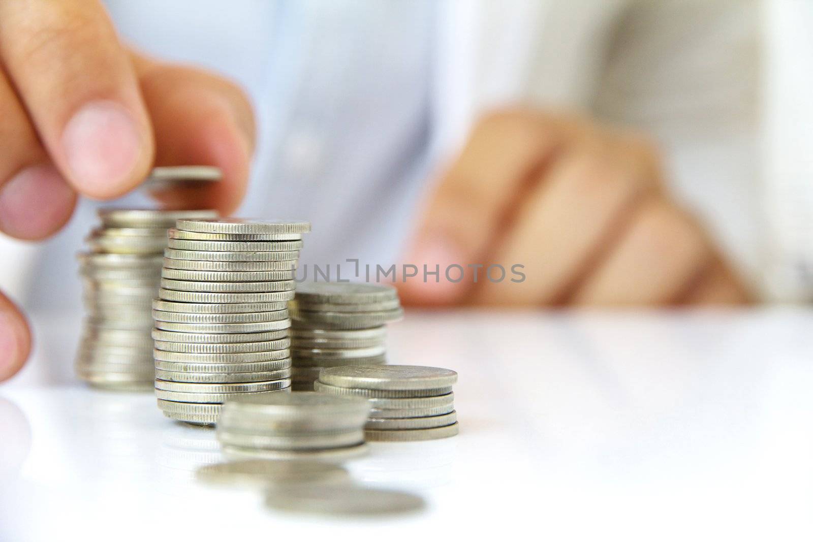 Hand holding coin stack, investment concept