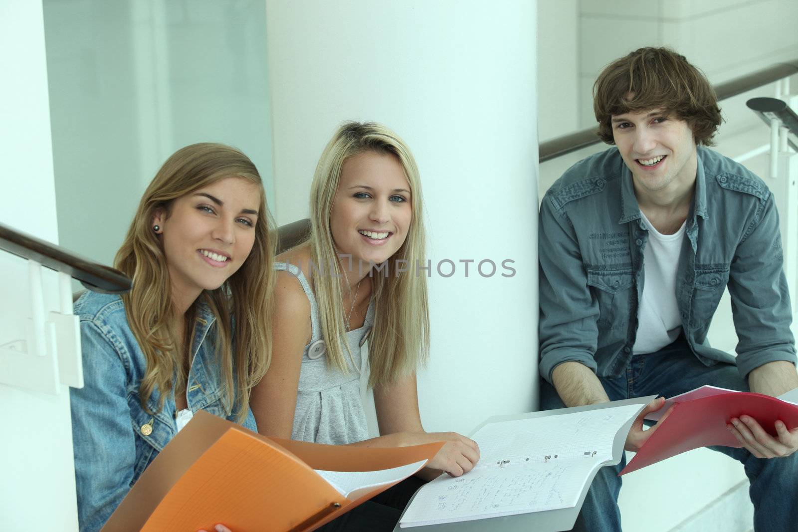 Teens doing homework by phovoir