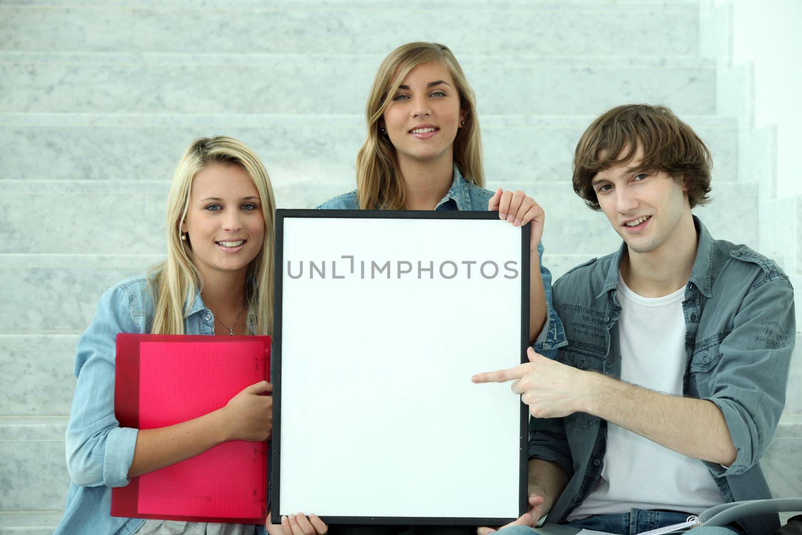 Students pointing at white board