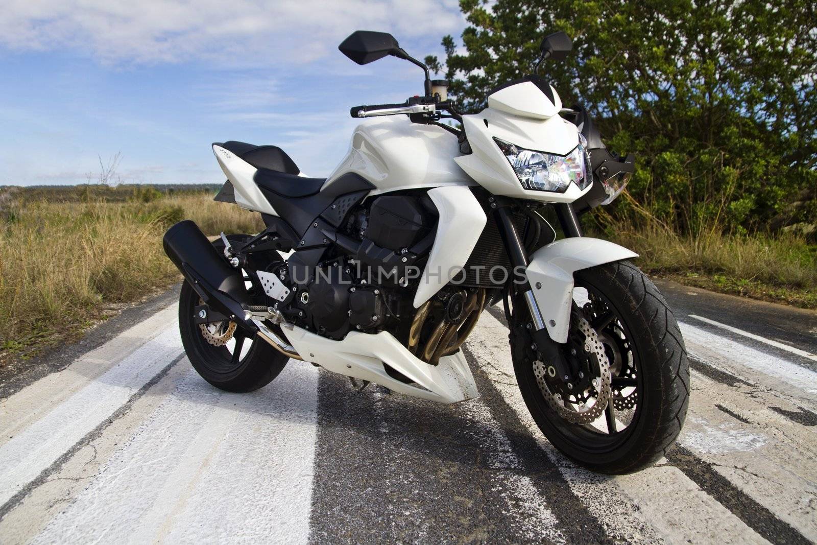 View of a high speed motorcycle on a asphalt road.