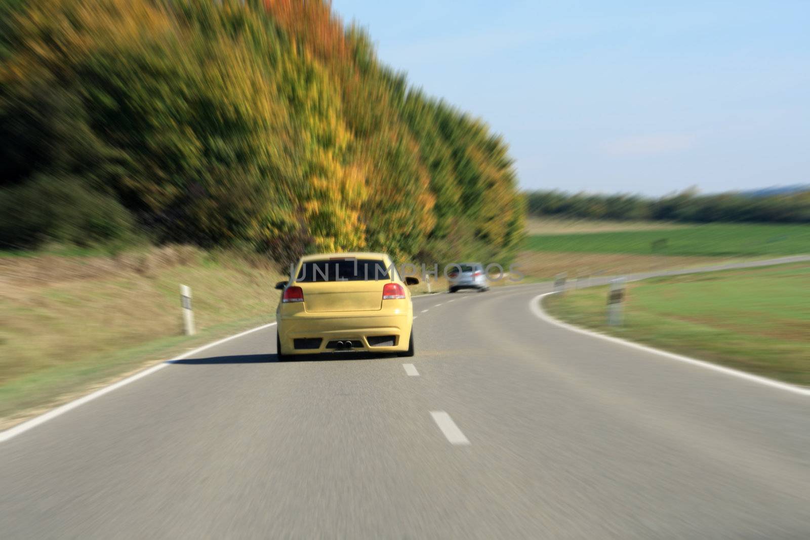 silver and yellow car driving on the road by photochecker