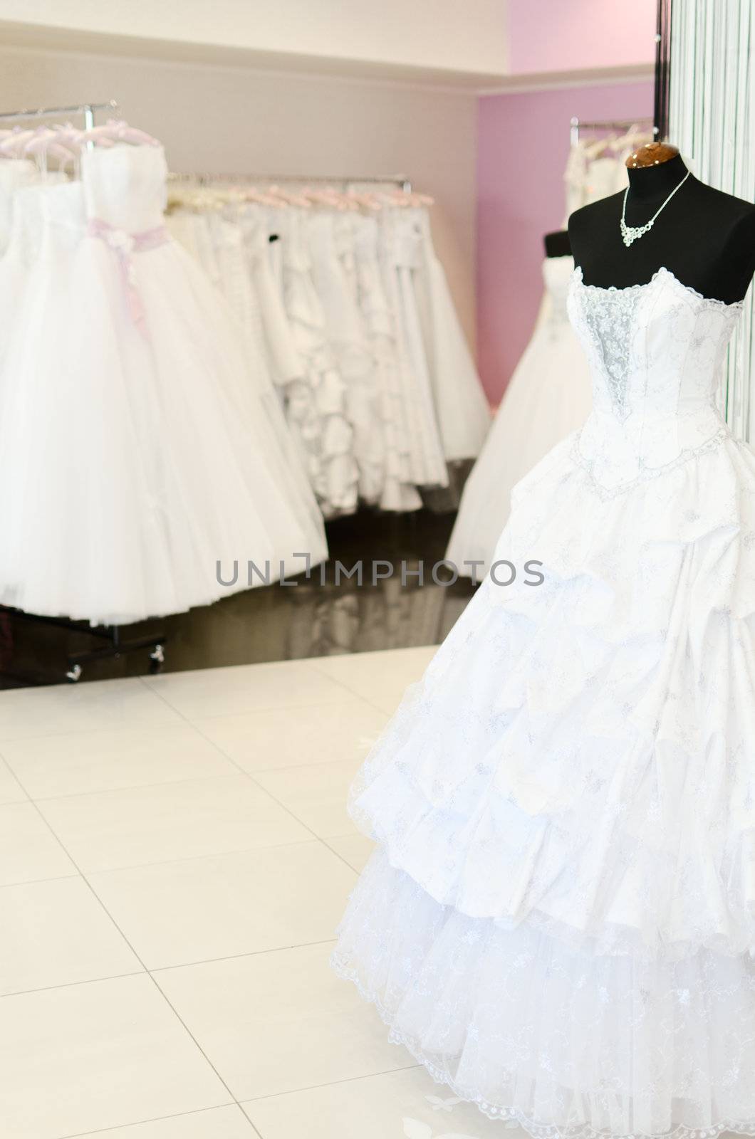 Wedding store background. White bridal dresses. Shallow depth of field