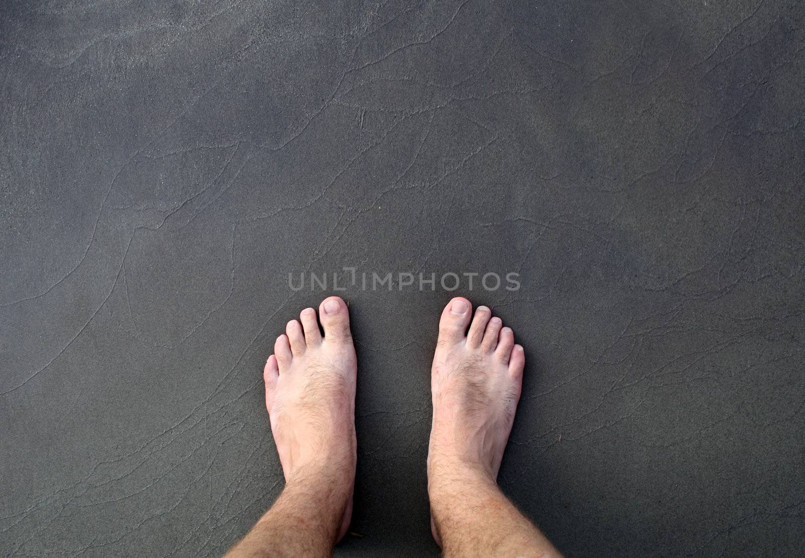 barefoot man on sea  by photochecker