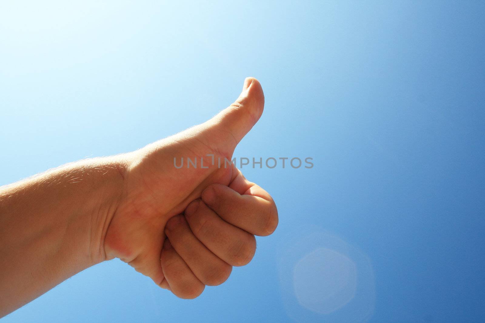 men's hand make thumbs up on blue sky