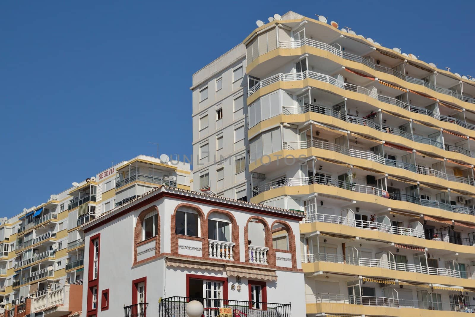 small house amid tall buildings in Velez-Malaga, 