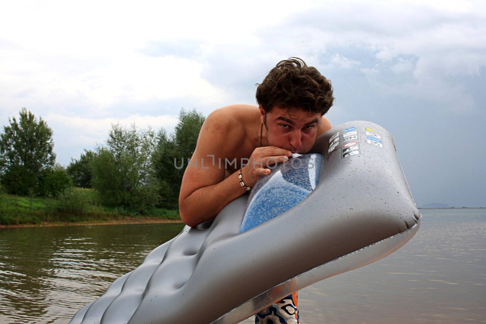 man on the inflatable beach mattress  