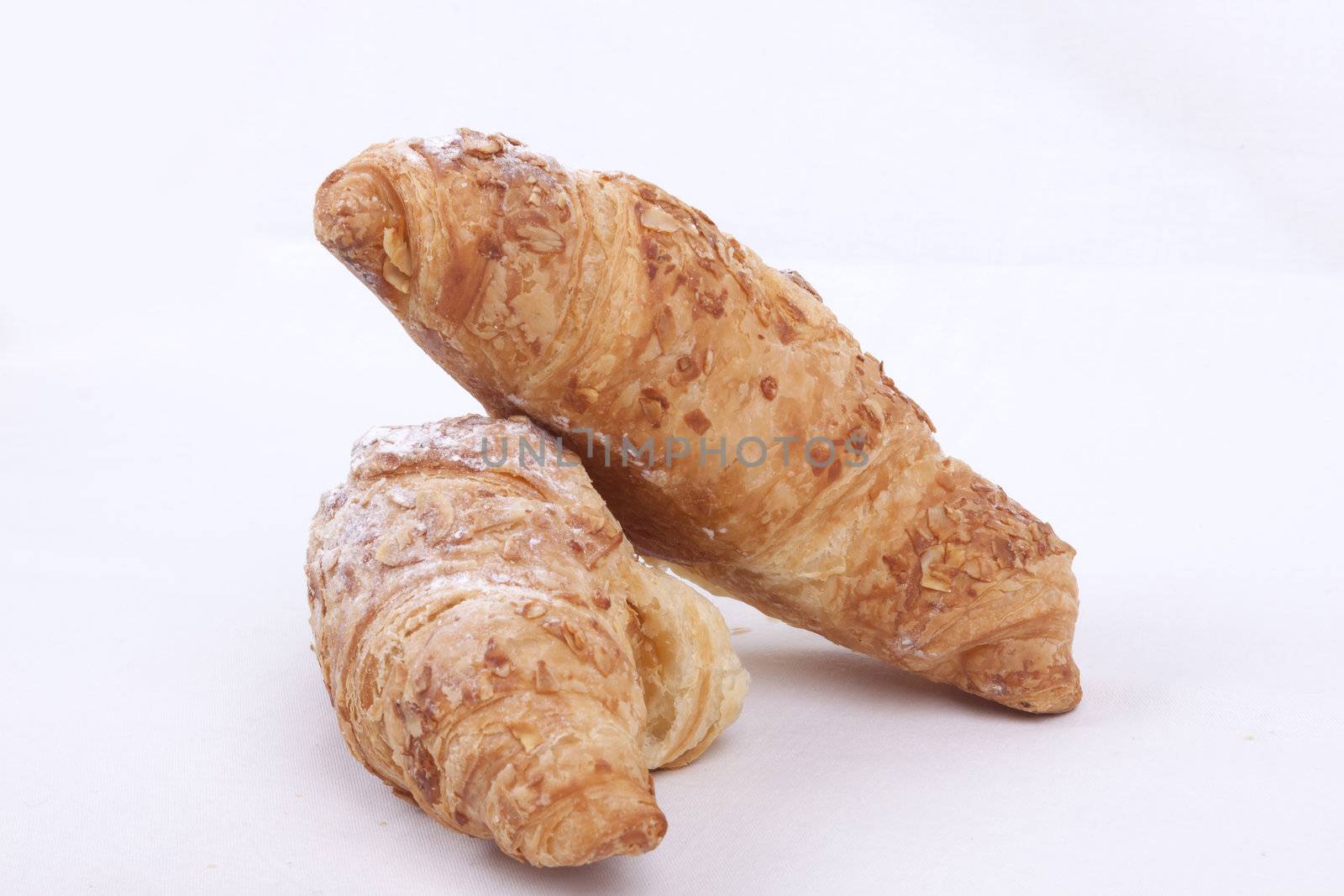 fresh almond croissant isolated on a white  background