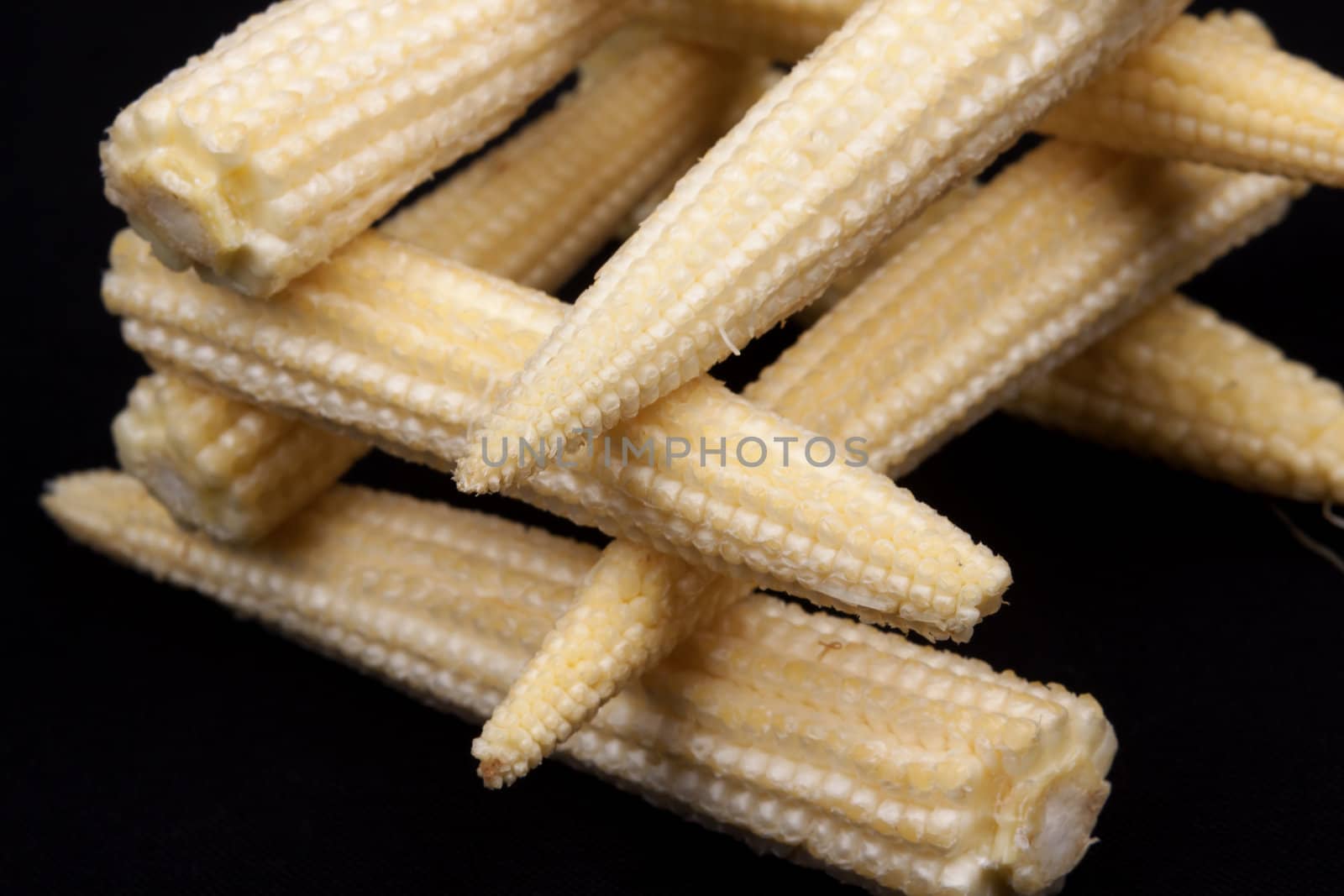 Baby corn  isolated on black background