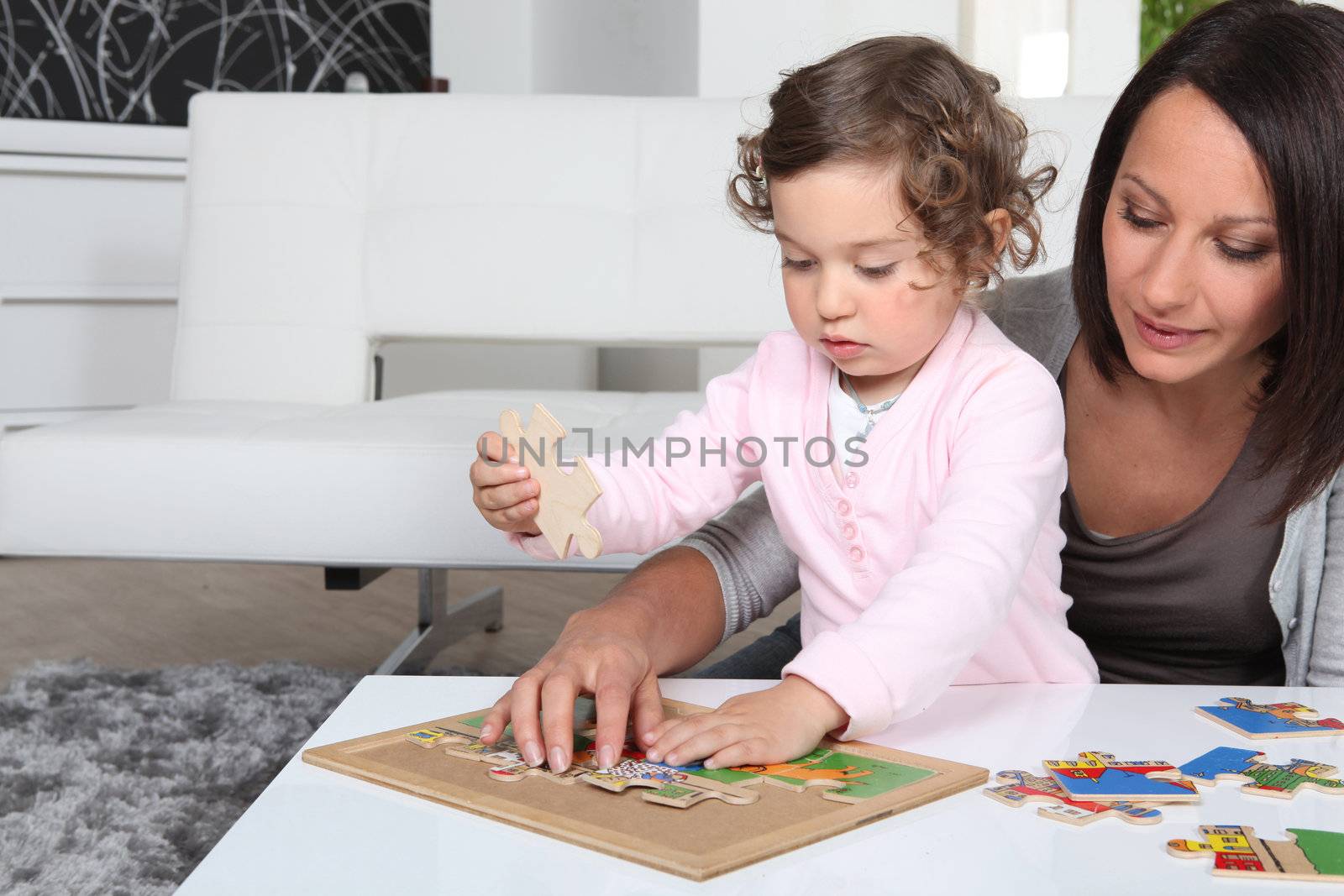 mother playing with her little girl by phovoir