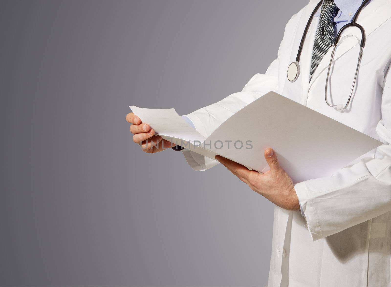 doctor reading clinic folder, isolated on grey background