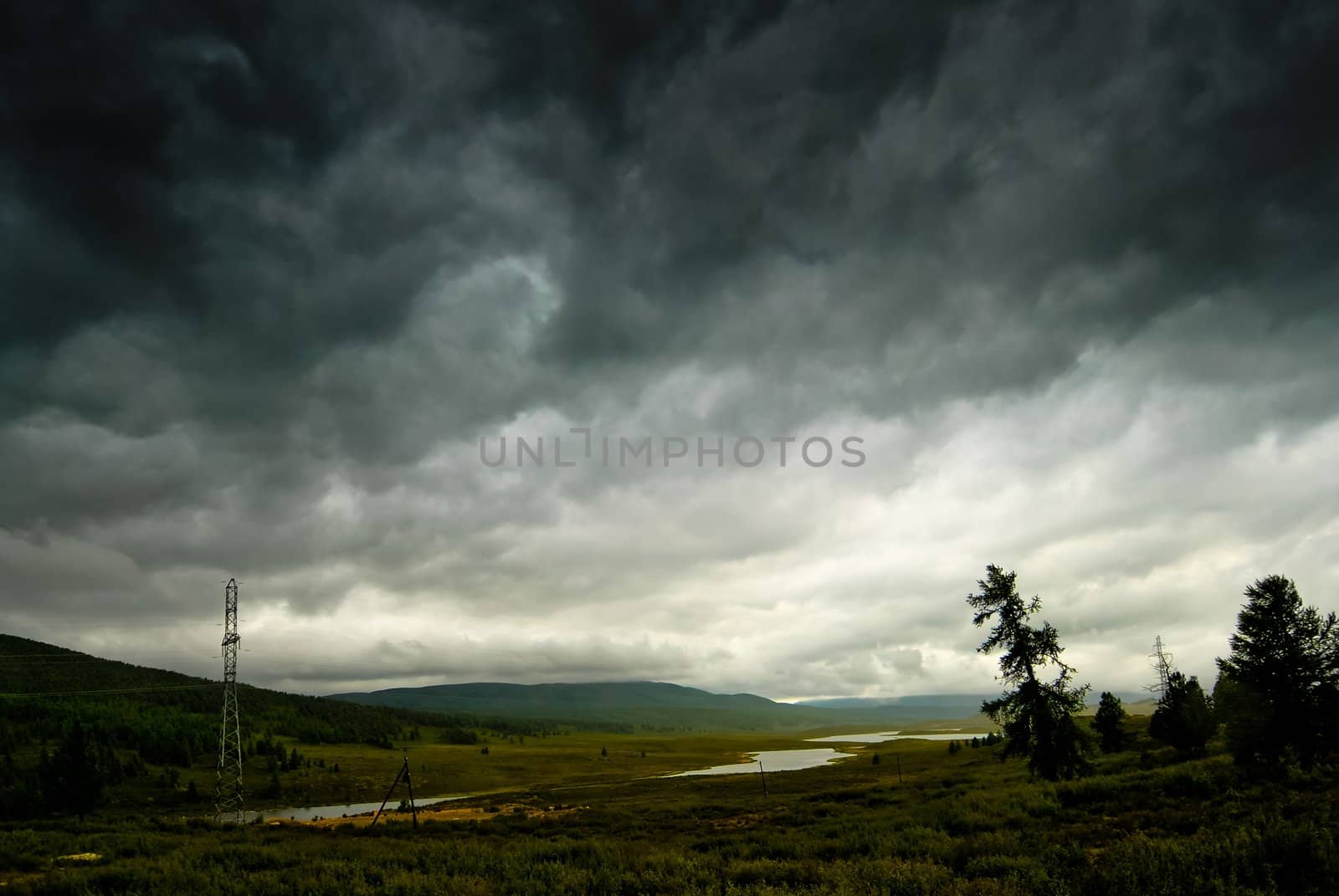 Black stormy sky in the rain in the mountains. Altai. Russia
