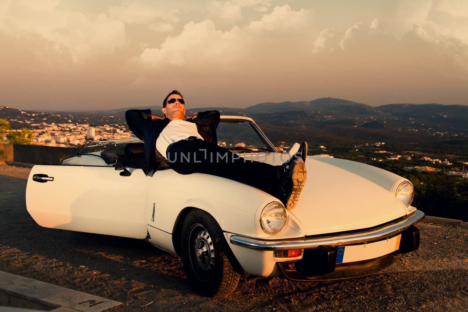 man with white convertible by membio