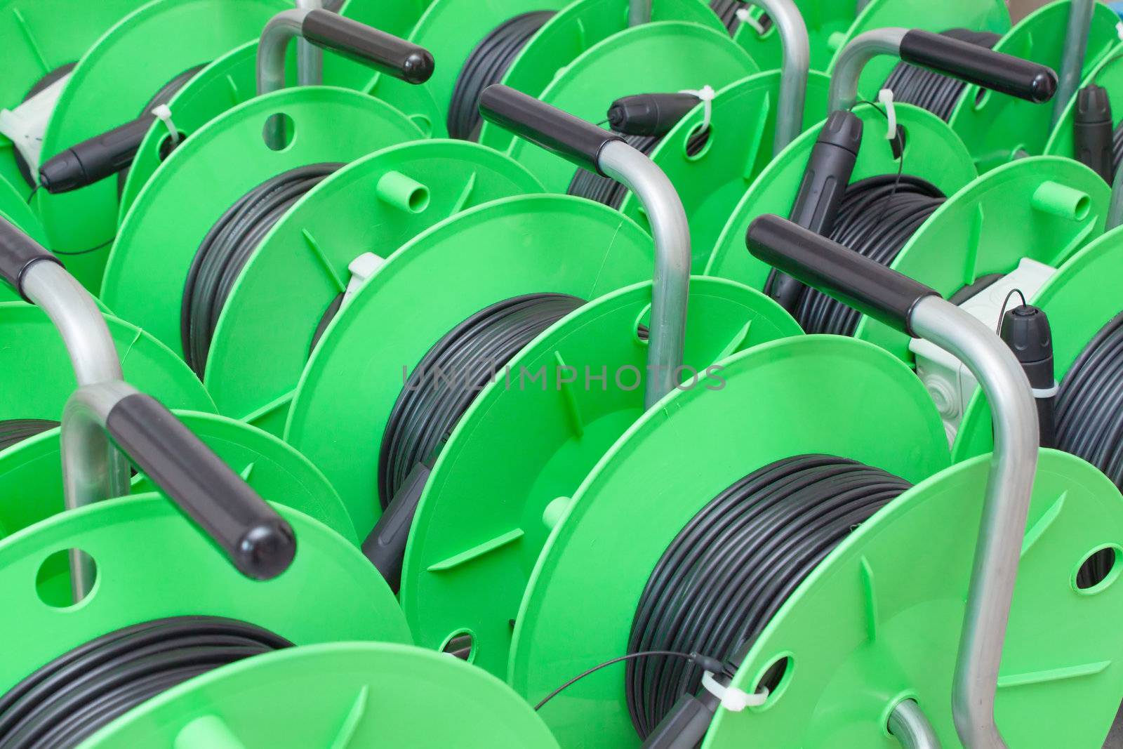 Group of green cable reels for new fiber optic installation