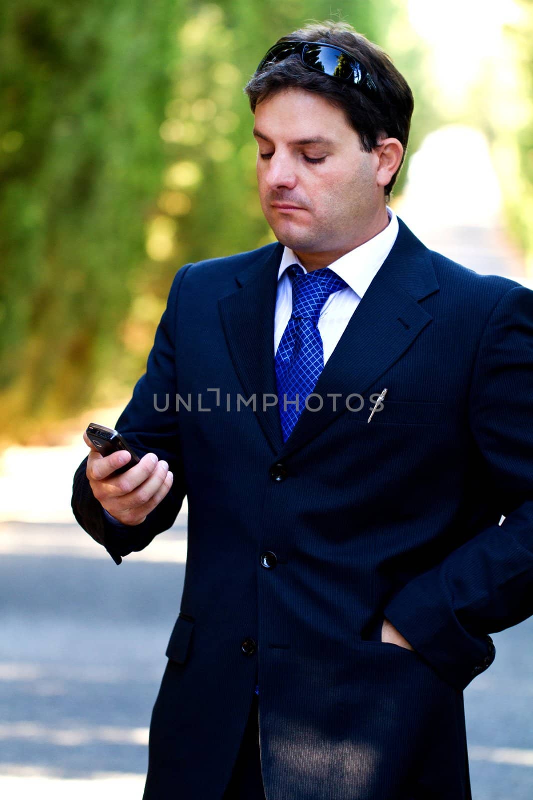 View of a young male business man on a asphalt road.