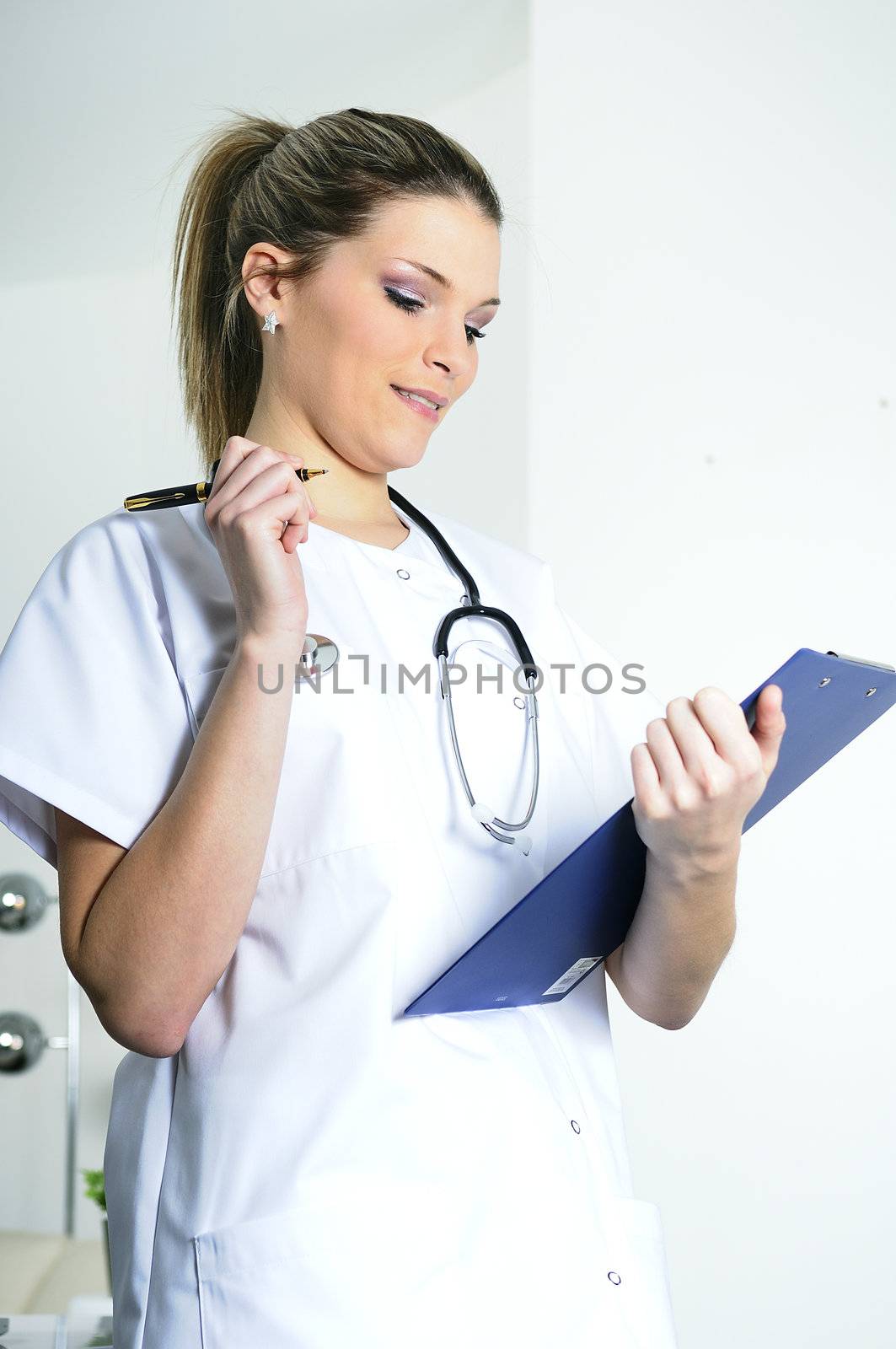 beautiful doctor in a hospital is writing and working