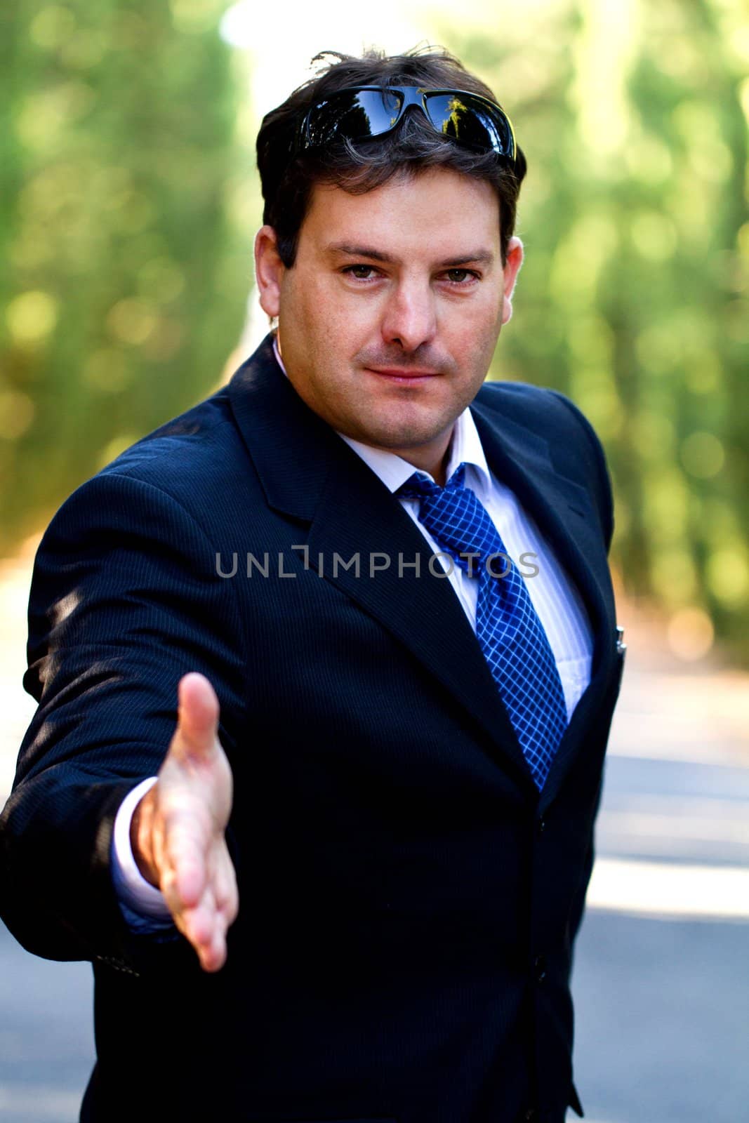 View of a young male business man on a asphalt road.