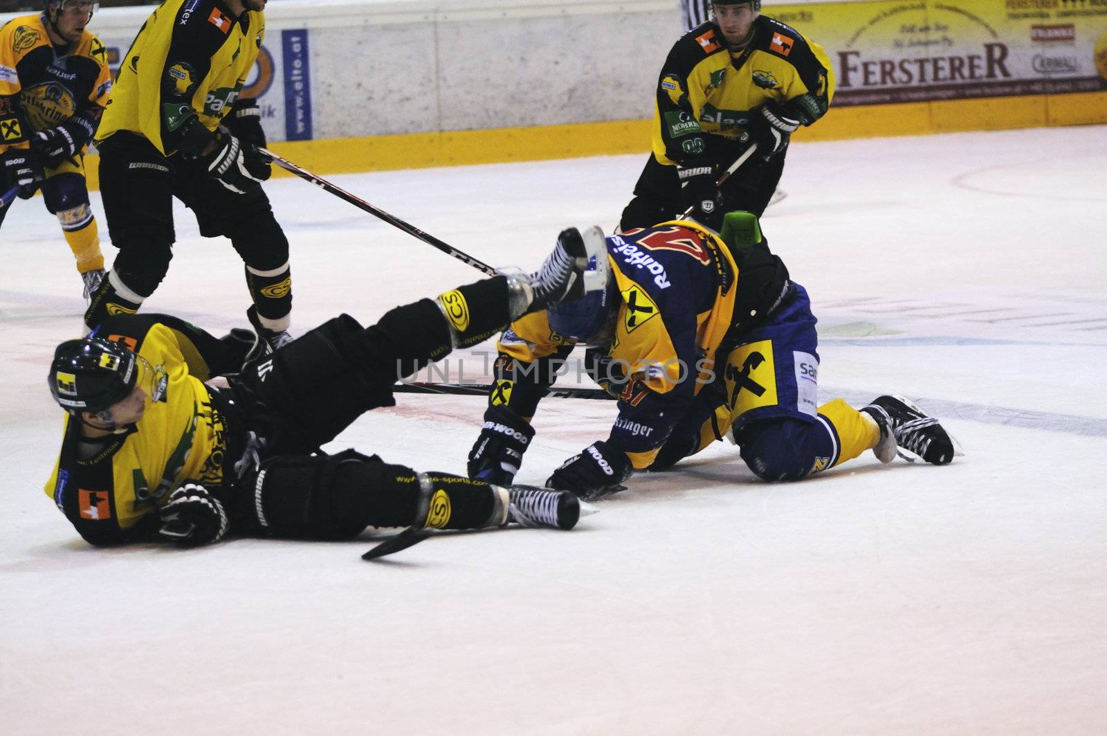 ZELL AM SEE; AUSTRIA - SEPT 24: Austrian National League. A player of Lustenau (yellow jersey) falls over a player of EKZ. Game EK Zell am See vs EHC Lustenau (Result 1-8) on September 24, 2011 in Zell am See.