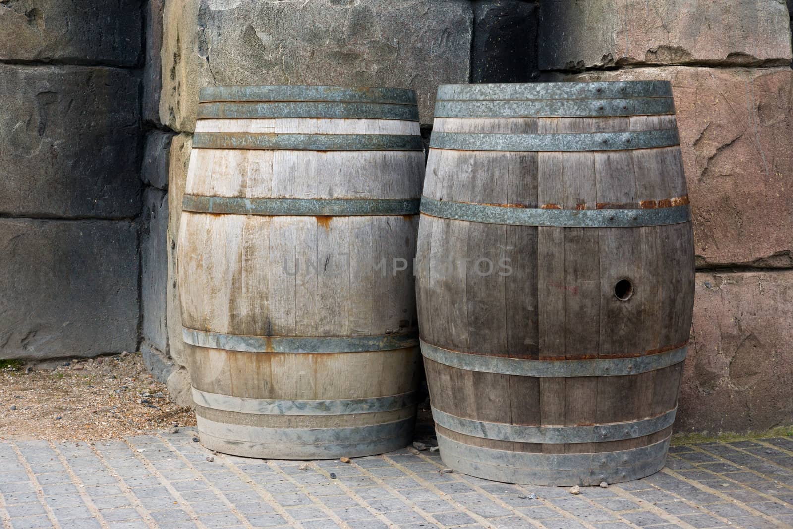 Old wooden barrels against a wall