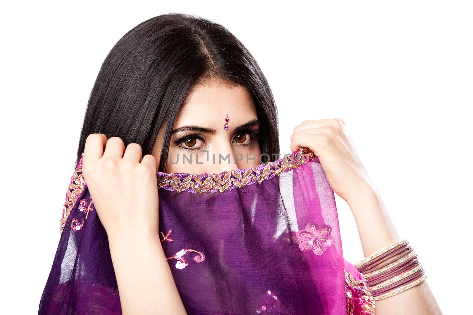 Beautiful Bengali Indian Hindu woman in colorful dress holding veil in front of face, isolated