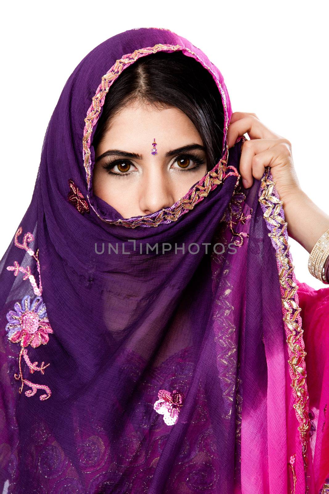 Beautiful Bengali Indian Hindu woman in colorful dress holding veil in front of face, isolated