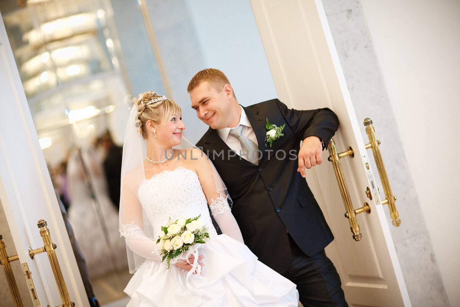 bride and groom at the opened doors