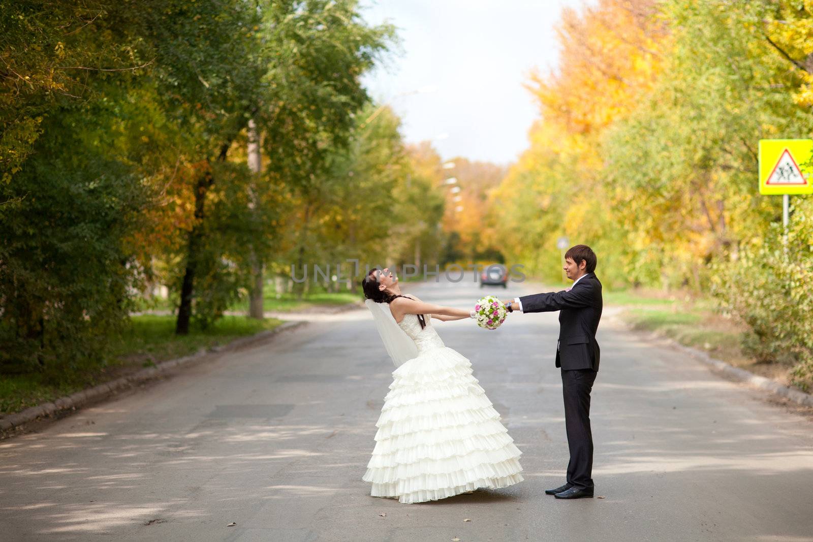 bride and groom on the road