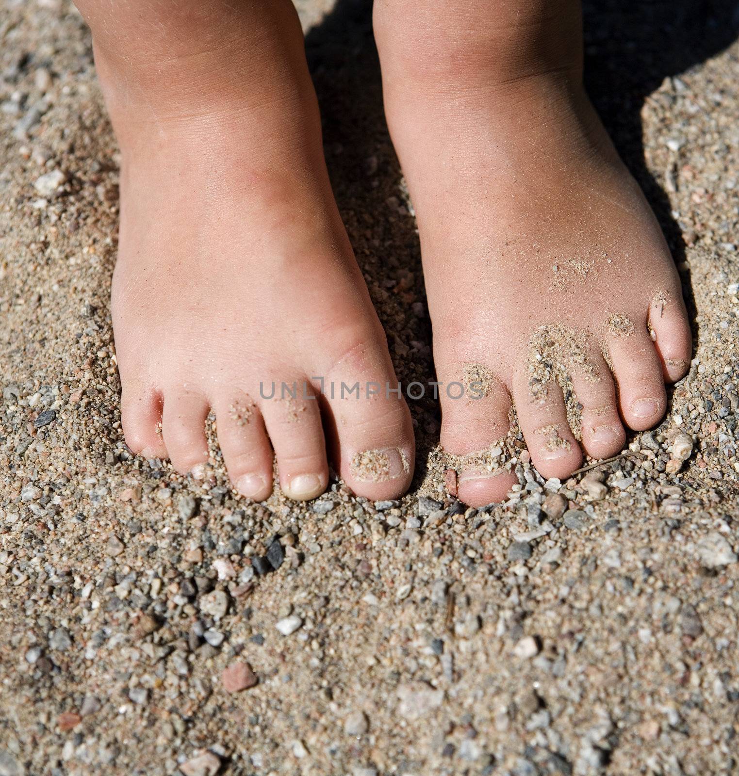 Babys feet in the sand