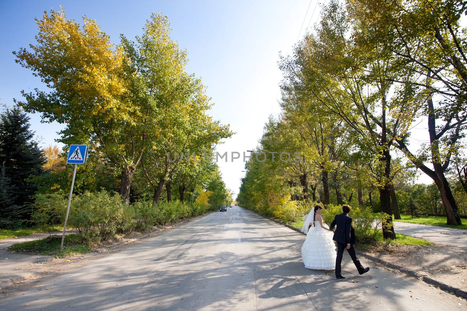 bride and groom crossing the road