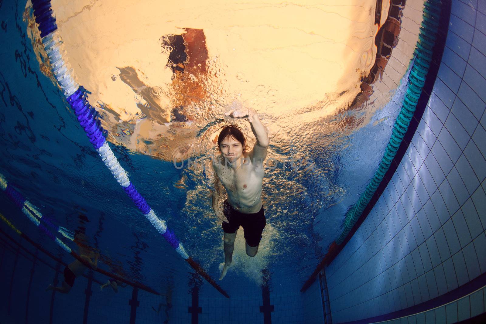 man underwater in swimming pool