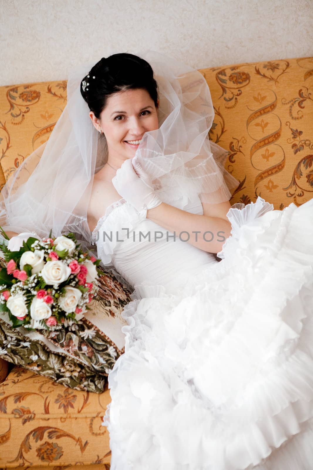 happy bride sit on the sofa