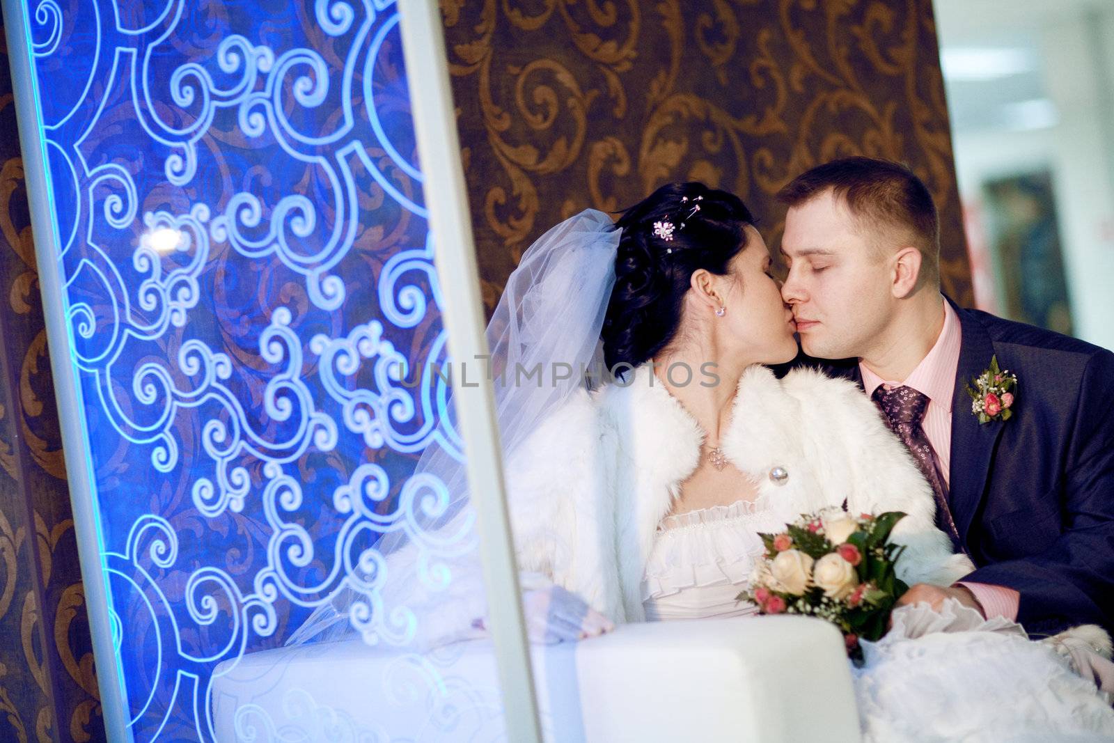 bride and groom near the ornate glass