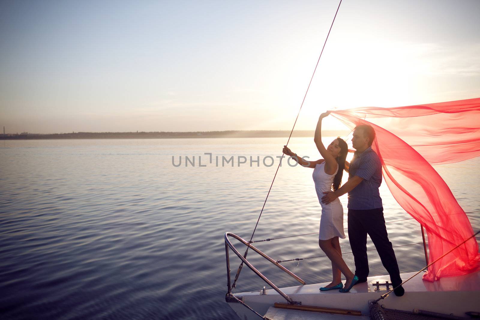 man and girl under the sail