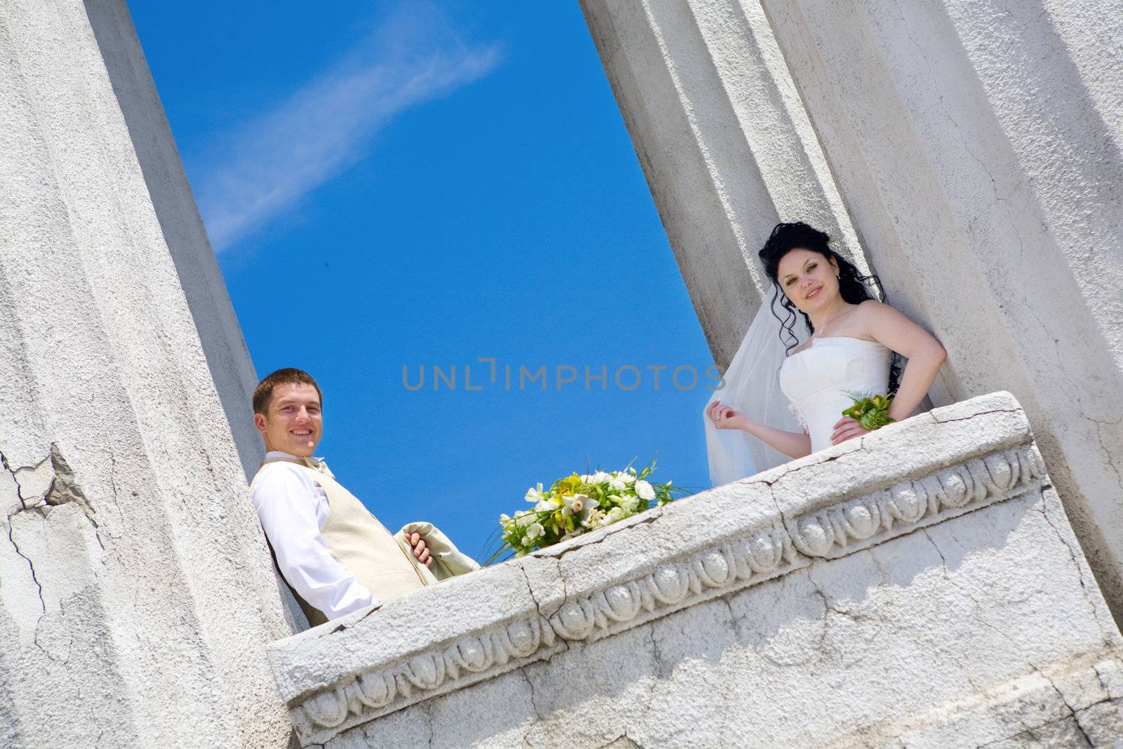 bride and groom in columns