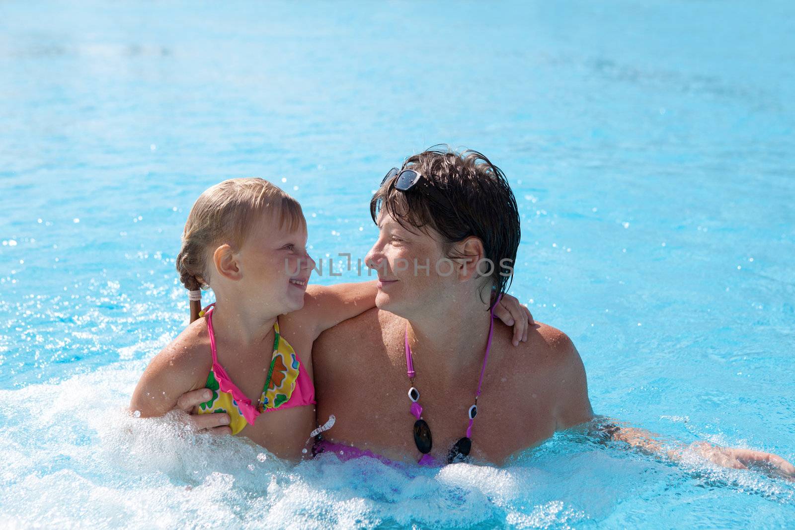 girl with grandmother in the swimming pool by vsurkov