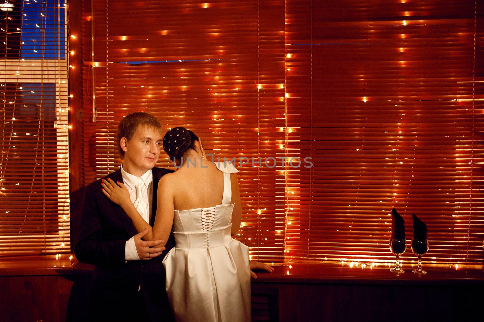 couple by the window with lights