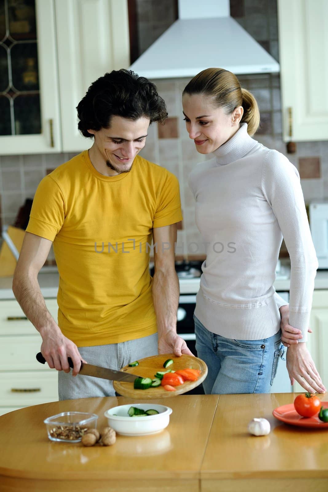 An image of couple in the kichen preparing vegetarian food
