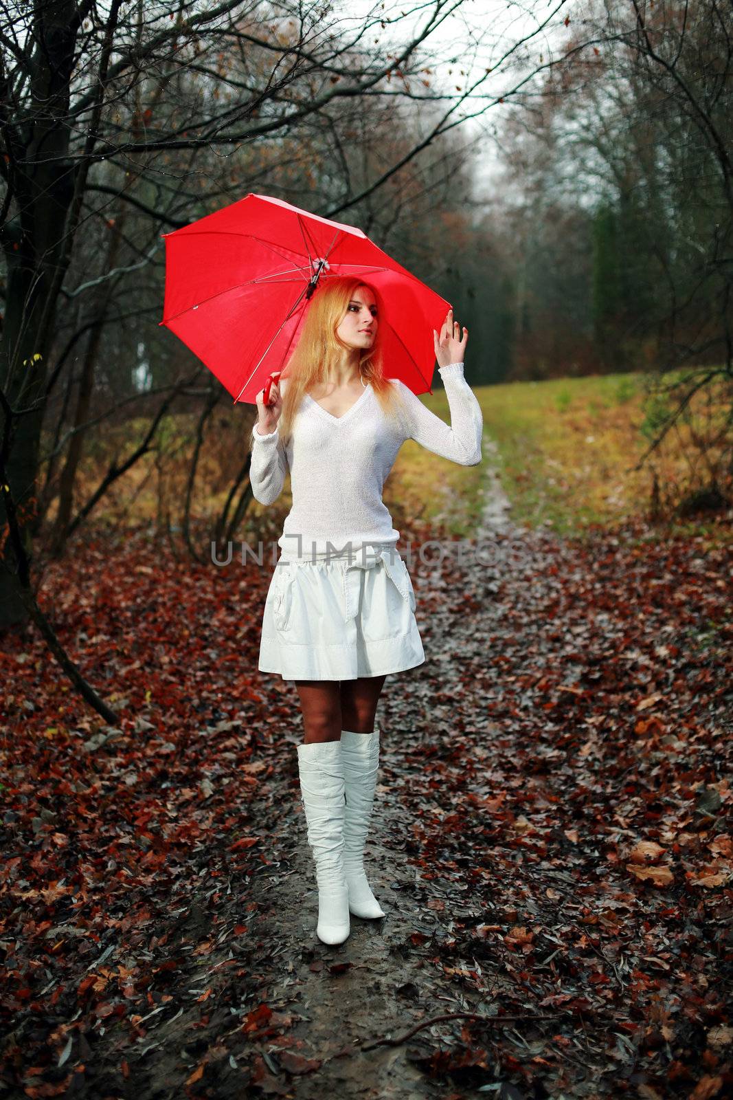 A woman with a red umbrella in the park