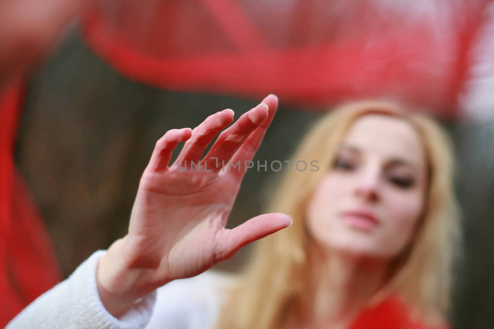 A nice woman with a red shawl in a forest