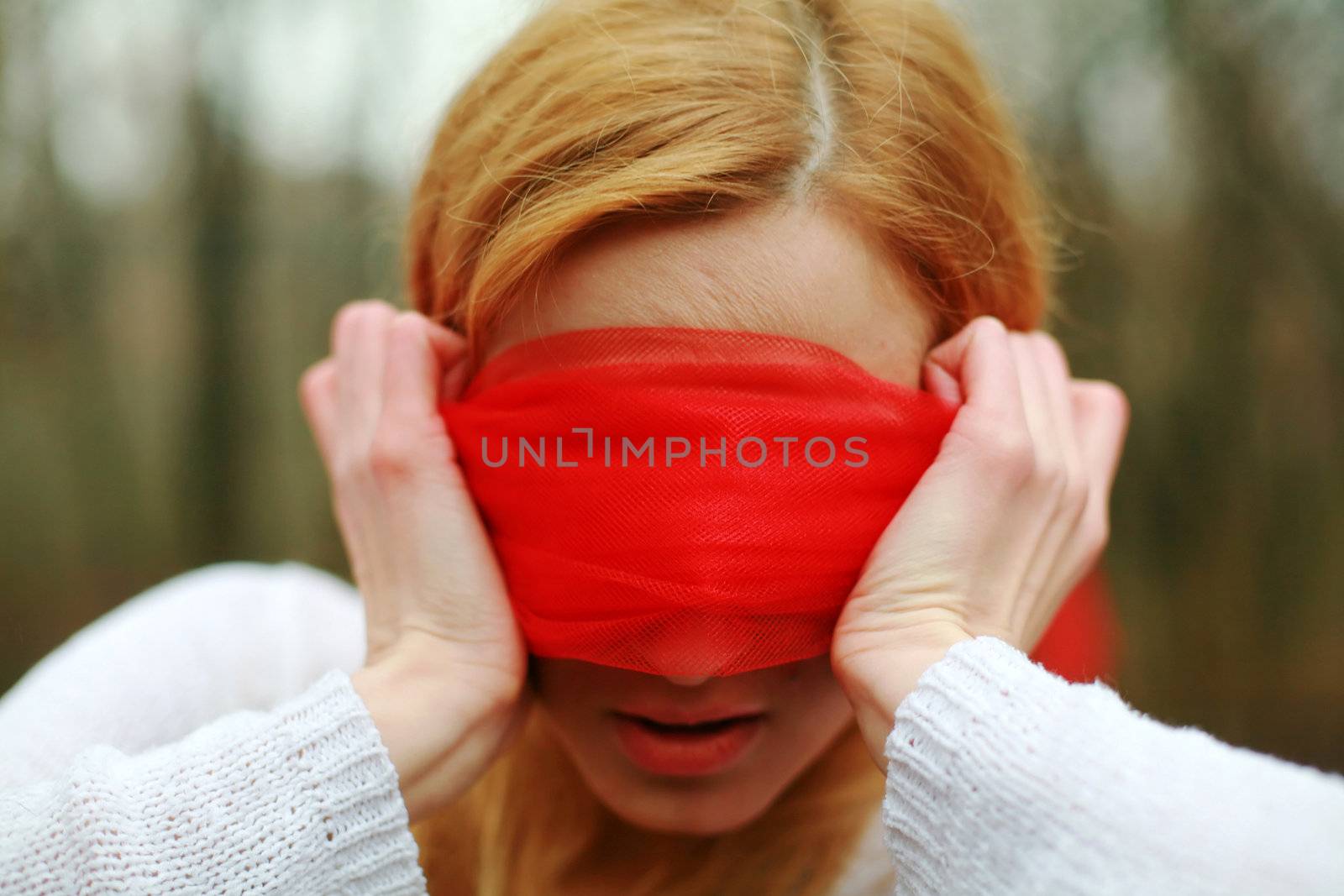 An image of blindfolded woman in the forest