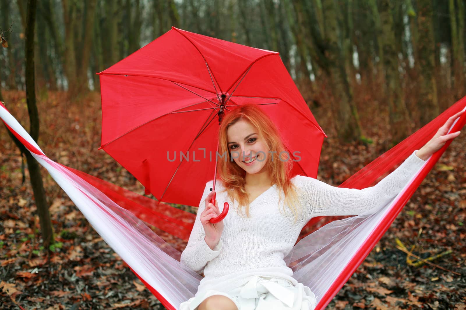 An image of happy girl with red umbrella