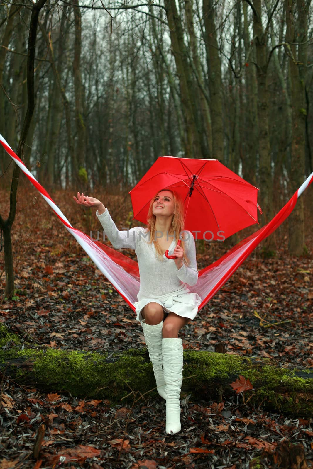 An image of a young woman with red umbrella