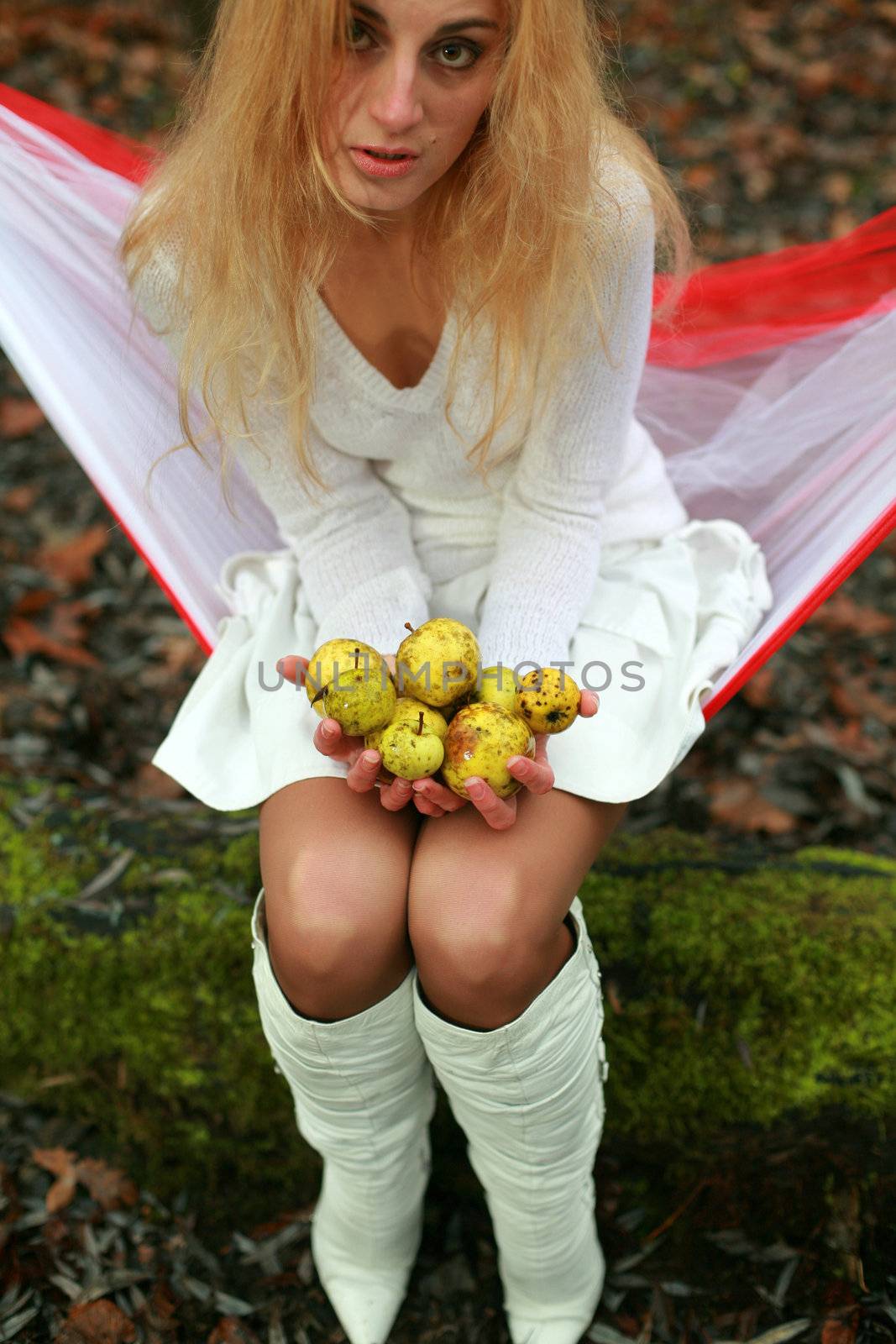 An image of woman with little yellow apples
