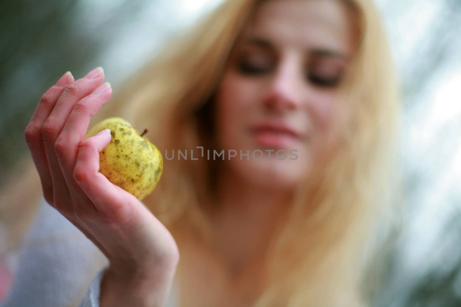 An image of woman with little yellow apple