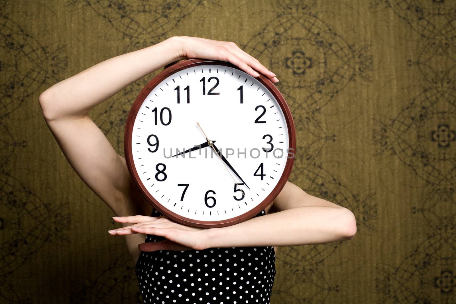 An image of a girl holding a big clock